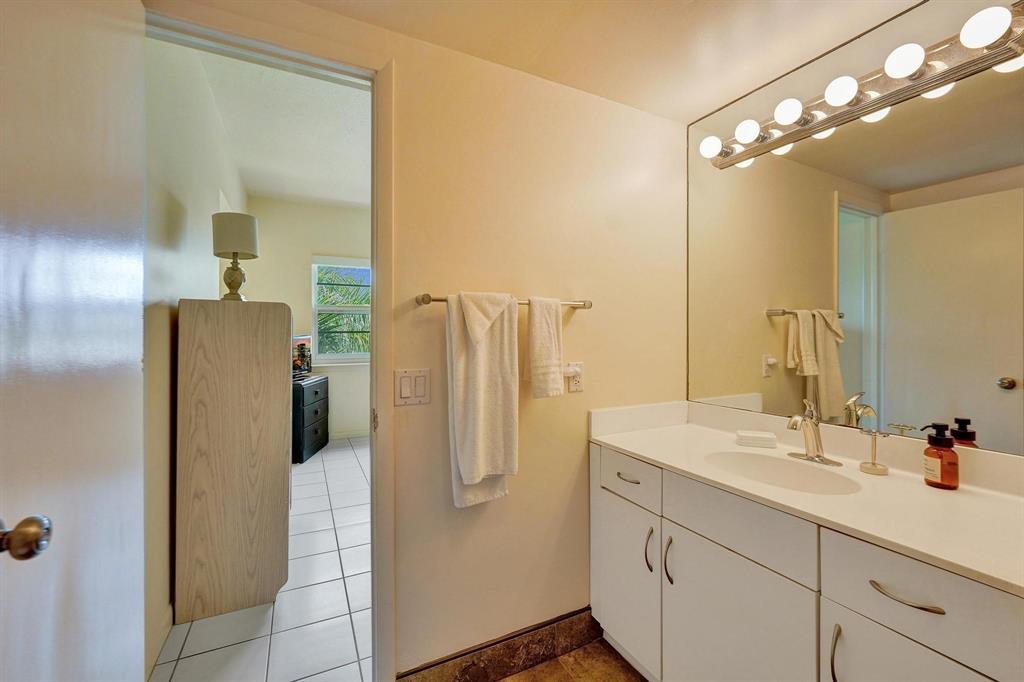 341 North Birch Road, Unit 416 Fort Lauderdale, FL 33304 - Photo 45 of 49 a bathroom with a double vanity sink and mirror