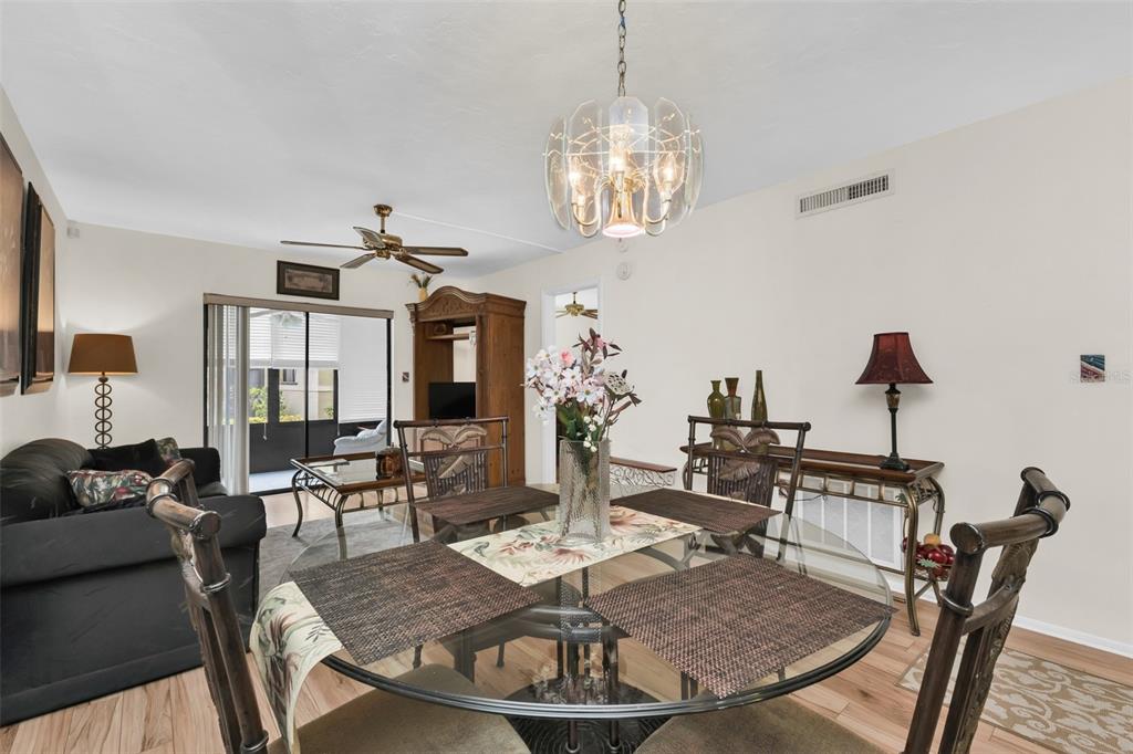 25225 Rampart Boulevard, Unit 1604 Punta Gorda, FL 33983 - Photo 8 of 41 a view of a dining room with furniture a chandelier and wooden floor
