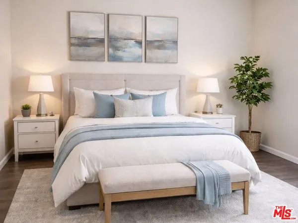 a bedroom with a bed and a potted plant