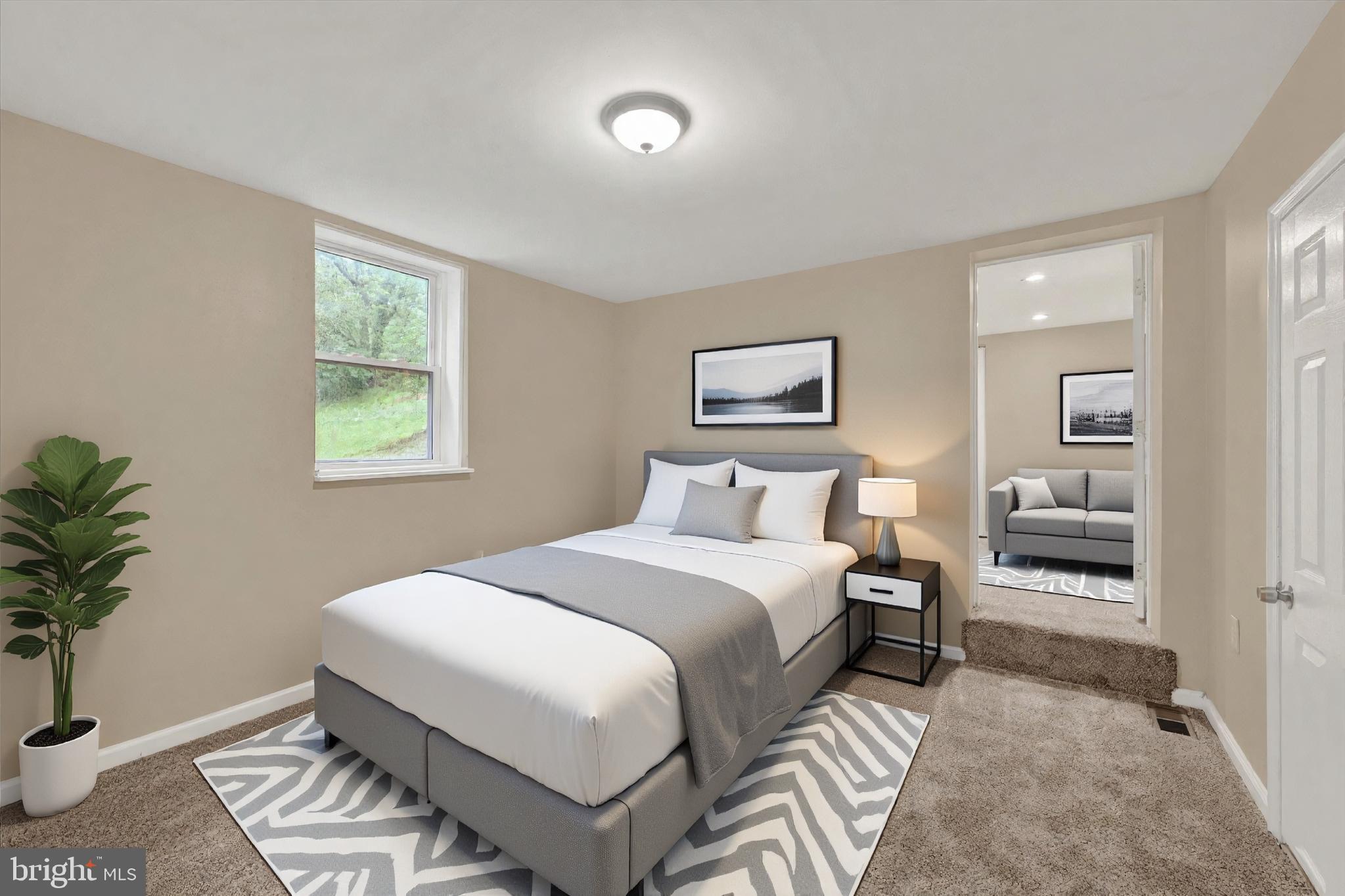 8511 Frederick Road Ellicott City, MD 21043 - Photo 23 of 36 a bedroom with a bed and a potted plant