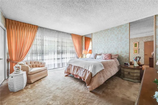 a spacious bedroom with a bed and a couch