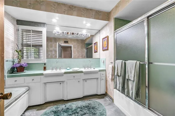 a bathroom with a double vanity sink and mirror