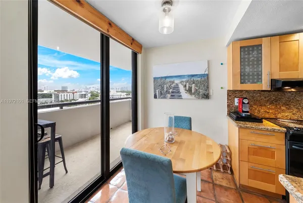 a kitchen with a table chairs and refrigerator