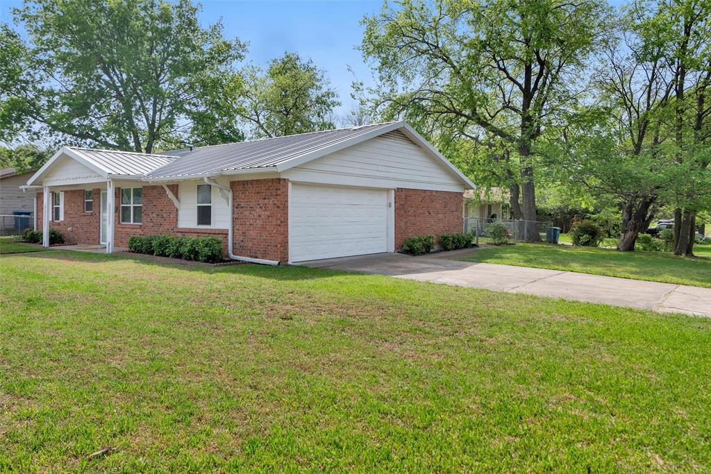 146 Bob White Road Denison, TX 75020 - Photo 2 of 25 Side entry garage from Wood Avenue