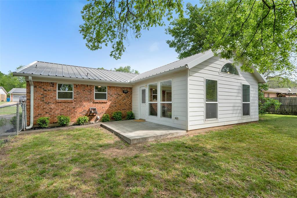 146 Bob White Road Denison, TX 75020 - Photo 22 of 25 Fully chain link fenced backyard and open patio on the west side