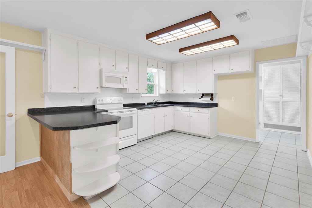 146 Bob White Road Denison, TX 75020 - Photo 9 of 25 Plenty of pantry space in the laundry room behind the louvered doors to the right