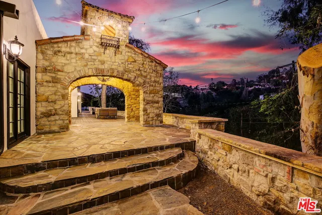 a view of a brick house with many windows