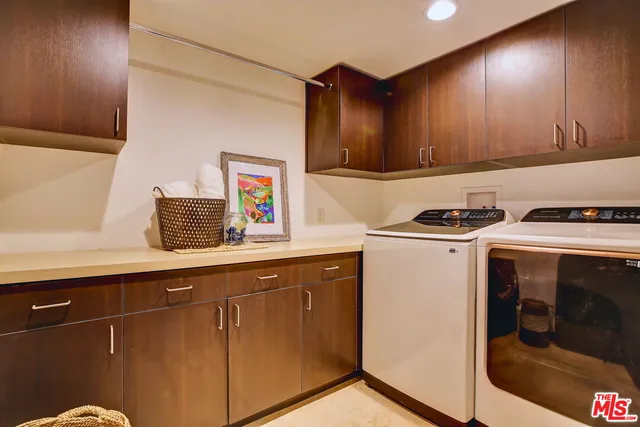 a bed sitting in a spacious bedroom next to a window