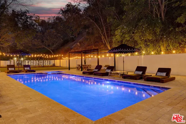 a view of yard with swimming pool and trees