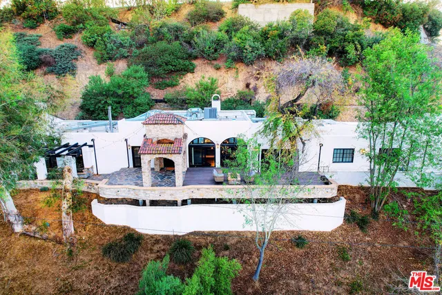 a aerial view of a house with swimming pool and a yard