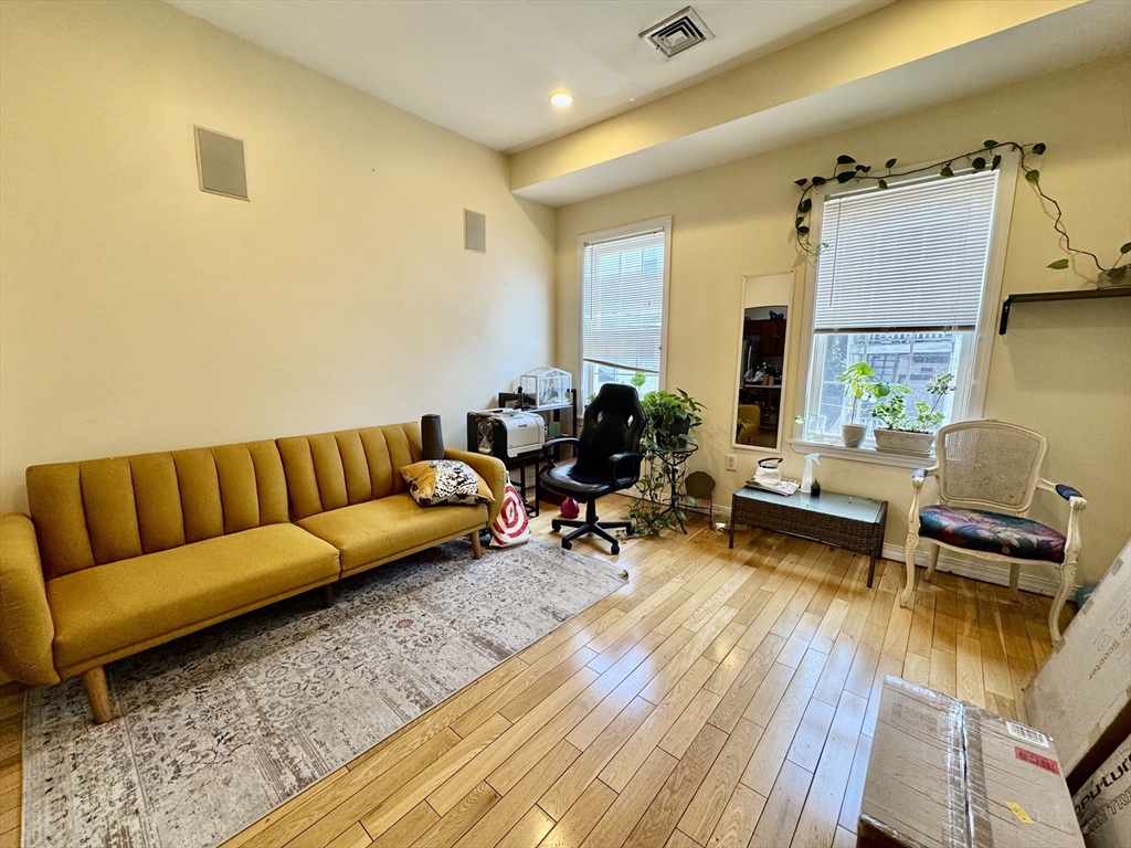 22 Elmore Street, Unit 2 Boston, MA 02119 - Photo 1 of 17 a living room with furniture and a wooden floor