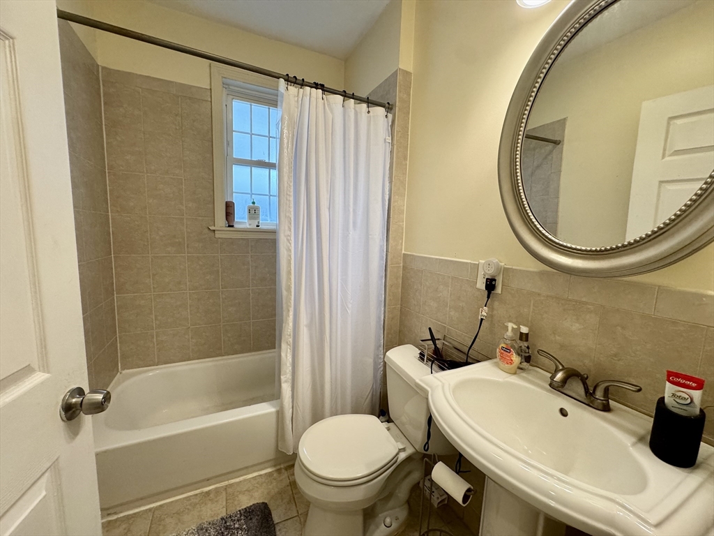 22 Elmore Street, Unit 2 Boston, MA 02119 - Photo 14 of 17 a bathroom with a sink and a mirror