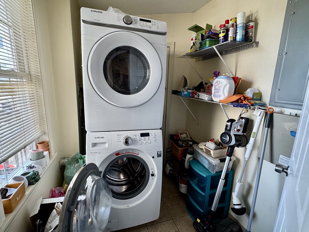 22 Elmore Street, Unit 2 Boston, MA 02119 - Photo 15 of 17 a utility room with dryer washer and a wooden floor