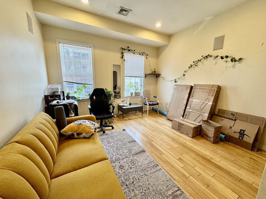22 Elmore Street, Unit 2 Boston, MA 02119 - Photo 2 of 17 a living room with furniture and a wooden floor