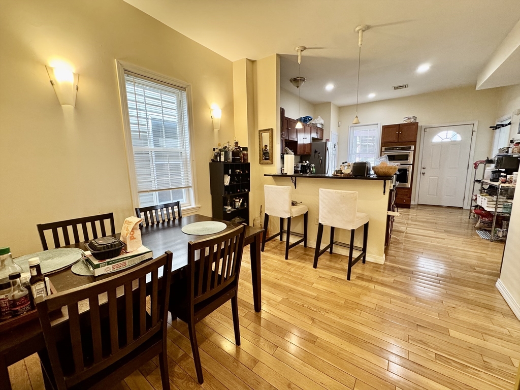 22 Elmore Street, Unit 2 Boston, MA 02119 - Photo 6 of 17 a dining room with furniture and wooden floor
