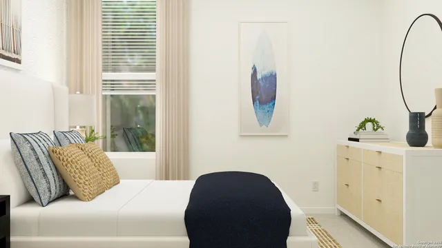 a bedroom with a bed and a window