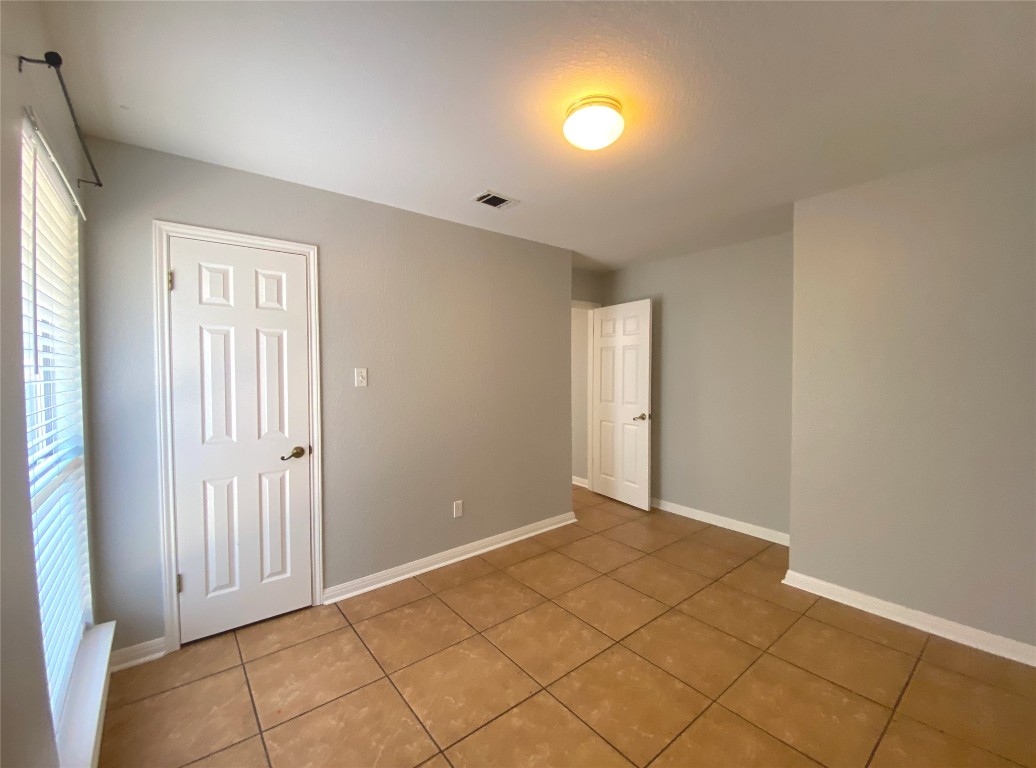 2308 Wright Circle Round Rock, TX 78664 - Photo 13 of 17 a view of an empty room with window and cabinet area