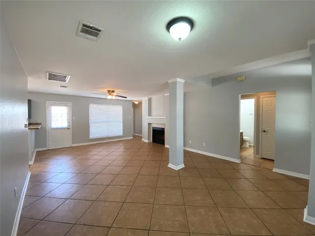 a view of an empty room and a window