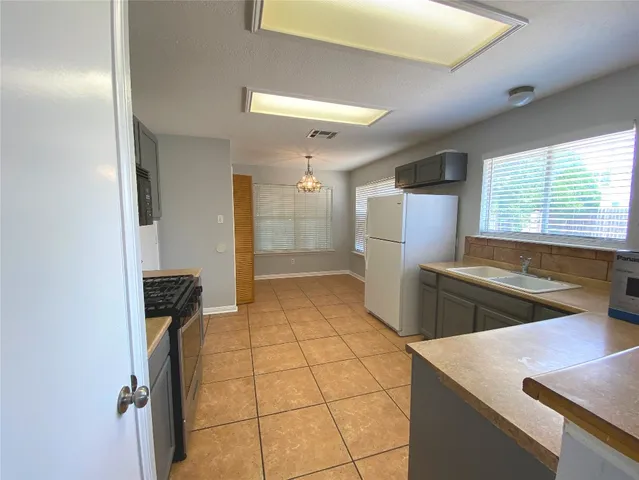 a kitchen with refrigerator and window