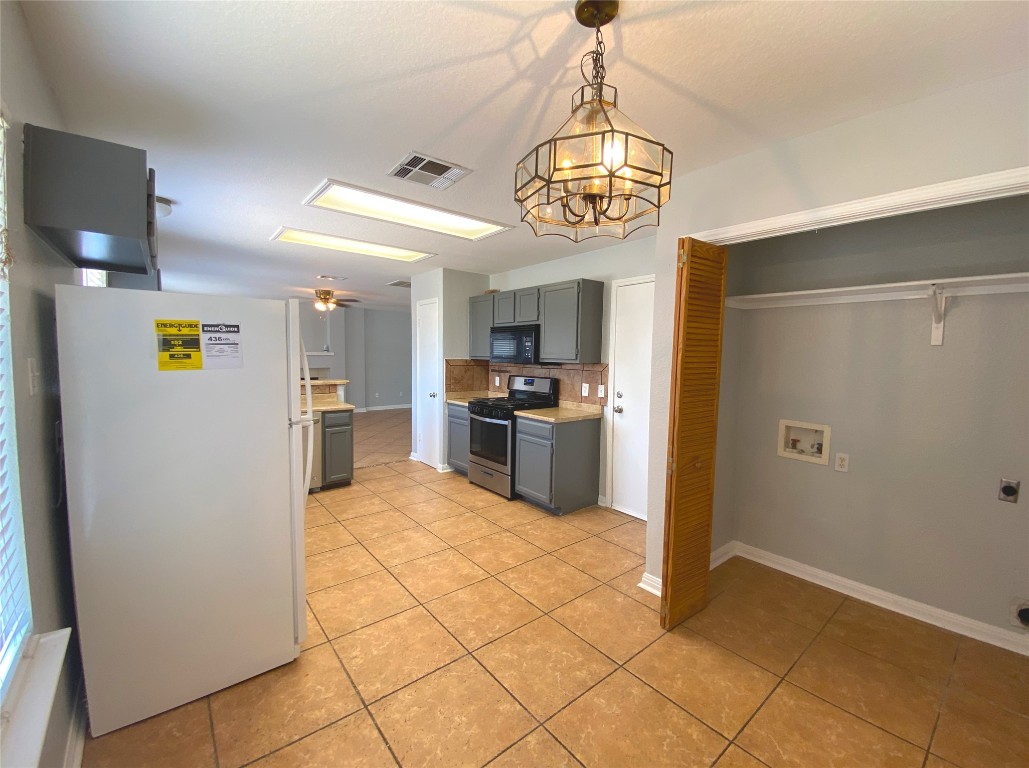 2308 Wright Circle Round Rock, TX 78664 - Photo 6 of 17 a kitchen with stainless steel appliances granite countertop a refrigerator and a stove top oven
