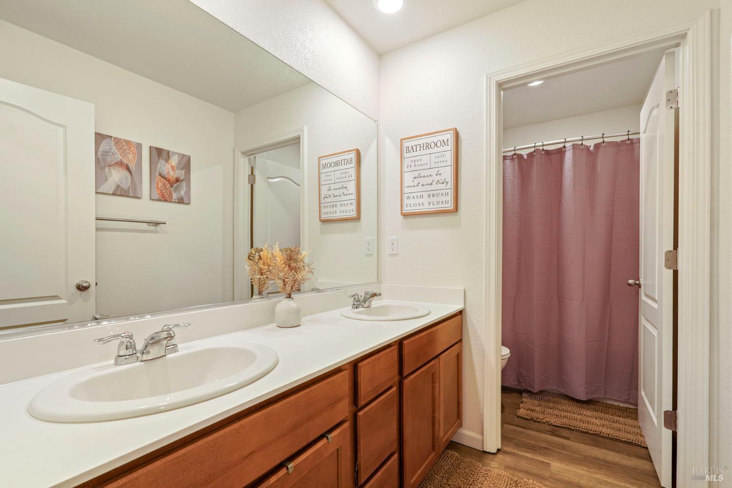 4725 Market Pl Square Rio Vista, CA 94571 - Photo 19 of 37 a bathroom with double vanity sinks a mirror and a shower