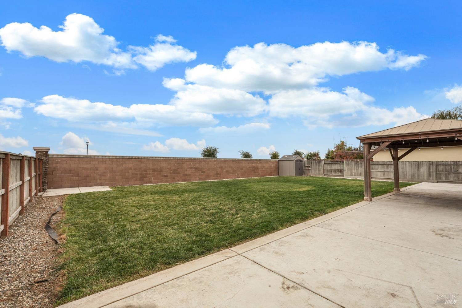 4725 Market Pl Square Rio Vista, CA 94571 - Photo 29 of 37 a view of a garden with a building in the background