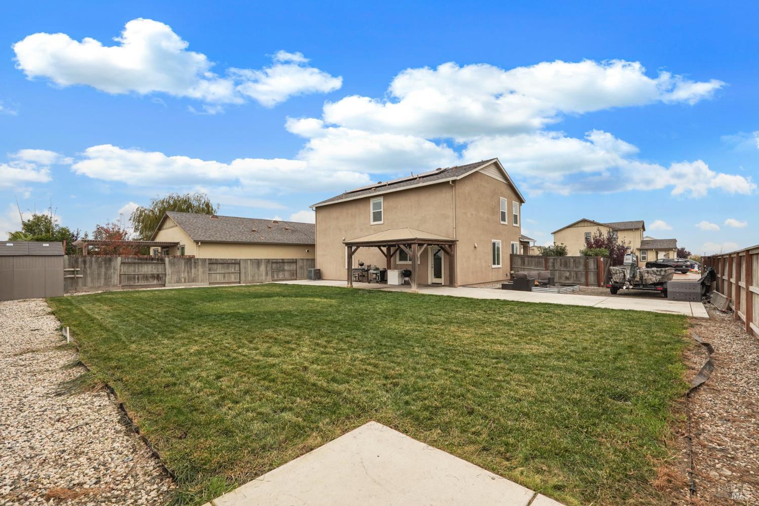 4725 Market Pl Square Rio Vista, CA 94571 - Photo 31 of 37 a view of a white house next to a yard with big trees