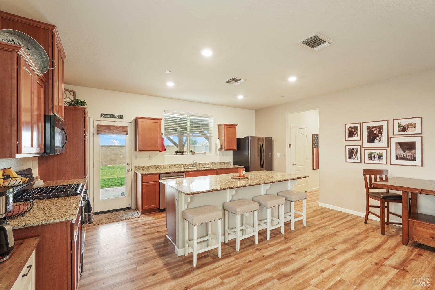 4725 Market Pl Square Rio Vista, CA 94571 - Photo 7 of 37 a kitchen with stainless steel appliances granite countertop a stove and a dining table