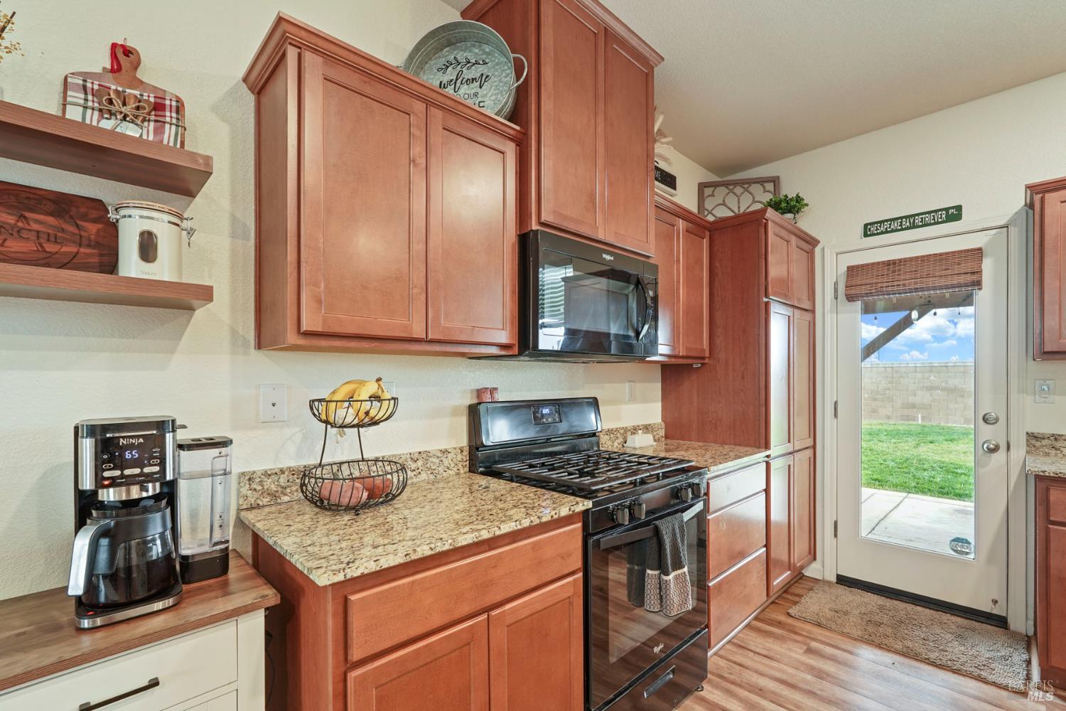 4725 Market Pl Square Rio Vista, CA 94571 - Photo 9 of 37 a kitchen with stainless steel appliances granite countertop a stove a sink and a microwave