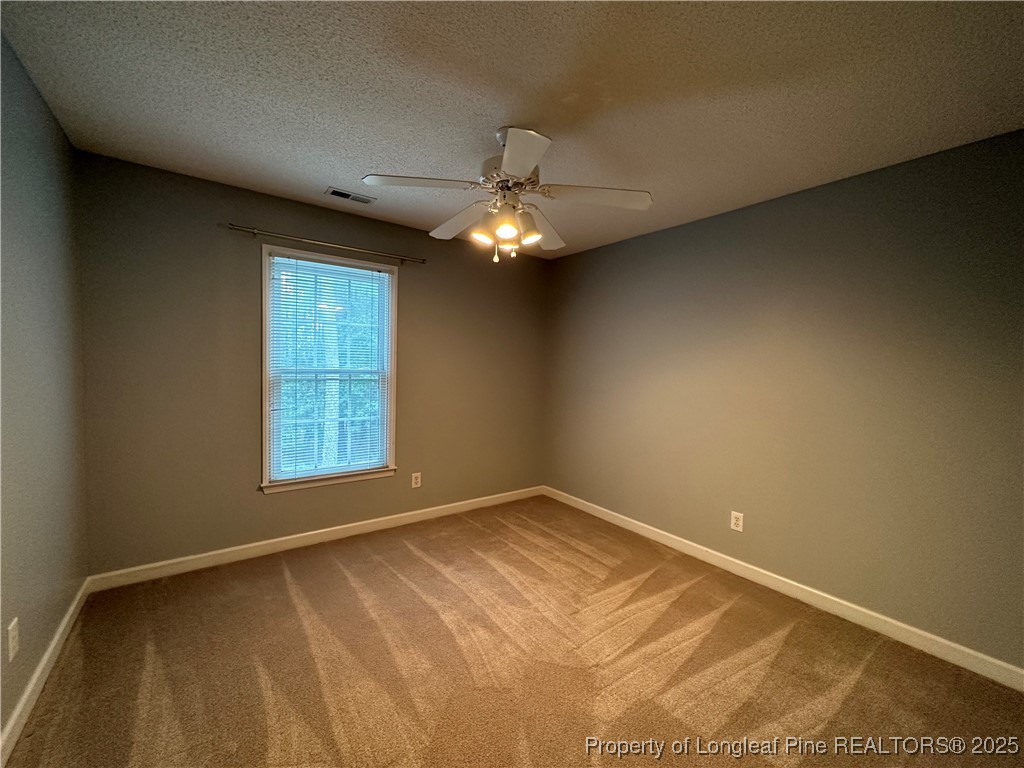 438 Crown Point Sanford, NC 27332 - Photo 11 of 15 an empty room with windows and fan