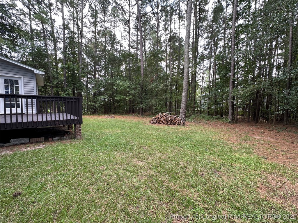 438 Crown Point Sanford, NC 27332 - Photo 15 of 15 a view of backyard with deck and a garden