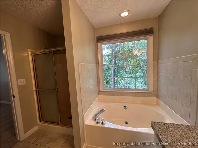 a bathroom with a tub and shower