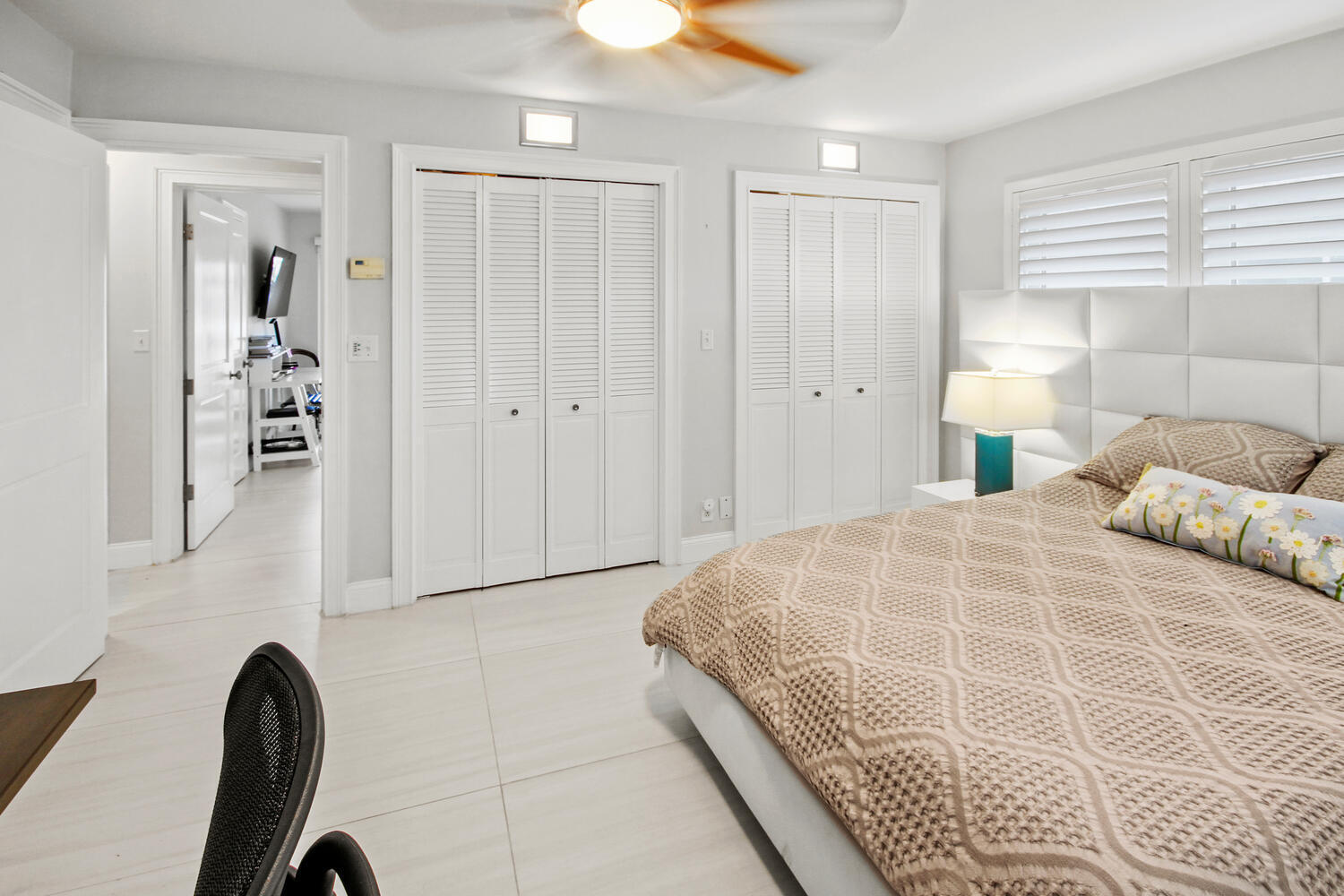 2425 Southeast 9th Street Pompano Beach, FL 33062 - Photo 23 of 91 a bedroom with a large bed and a chandelier