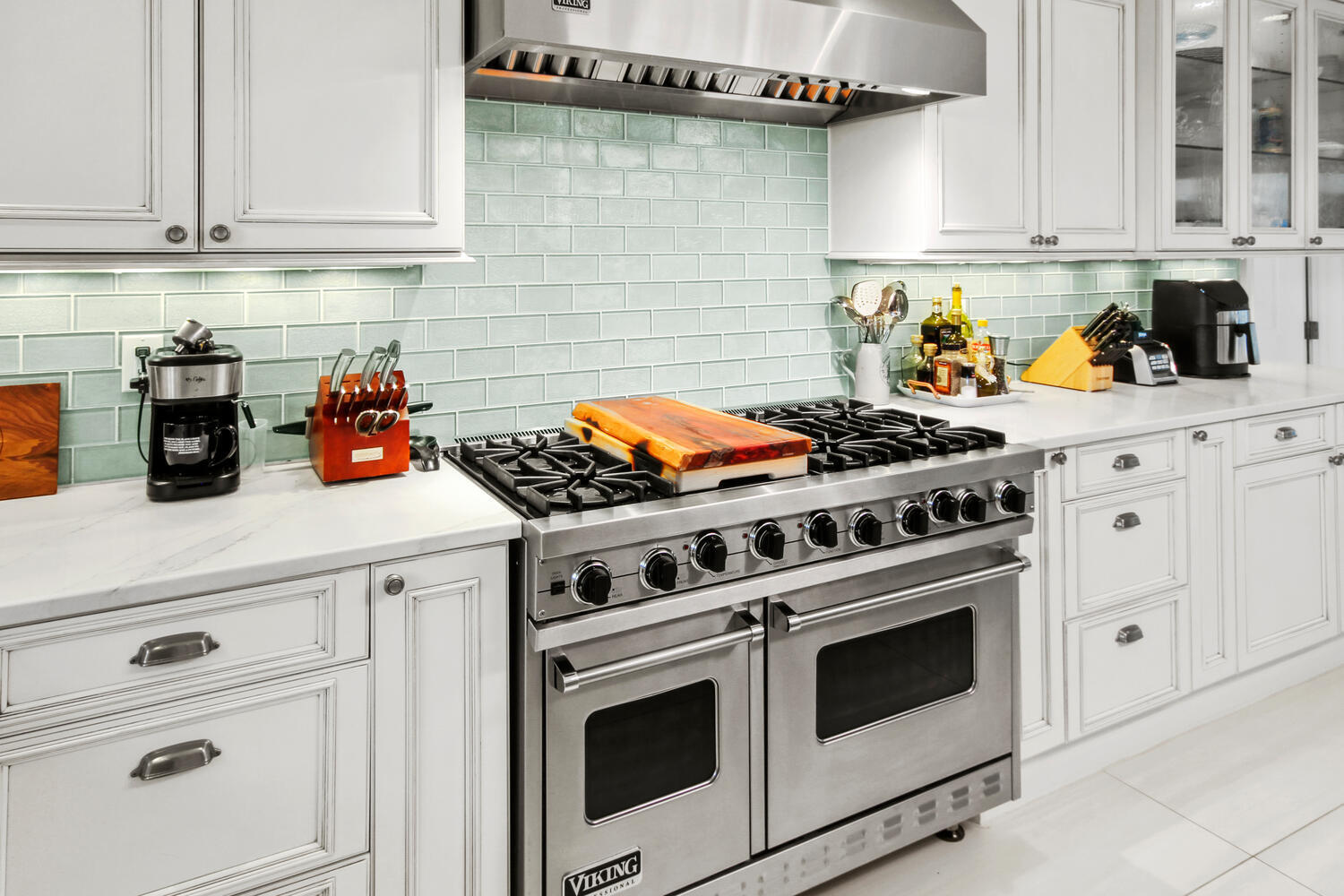 2425 Southeast 9th Street Pompano Beach, FL 33062 - Photo 6 of 91 a kitchen with a stove and white cabinets