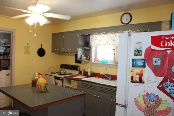 a kitchen with a sink cabinets and window