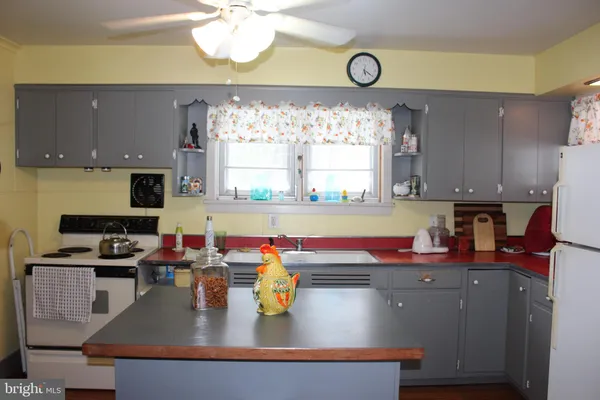 a kitchen with a stove a sink and a refrigerator
