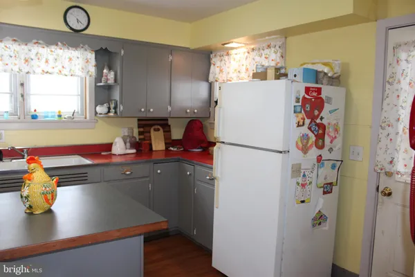 a kitchen with a refrigerator and a sink