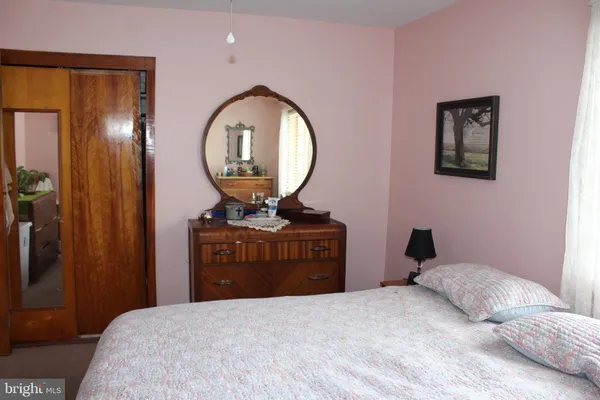 a bedroom with a bed and a mirror