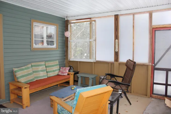 a reading room with furniture and a window