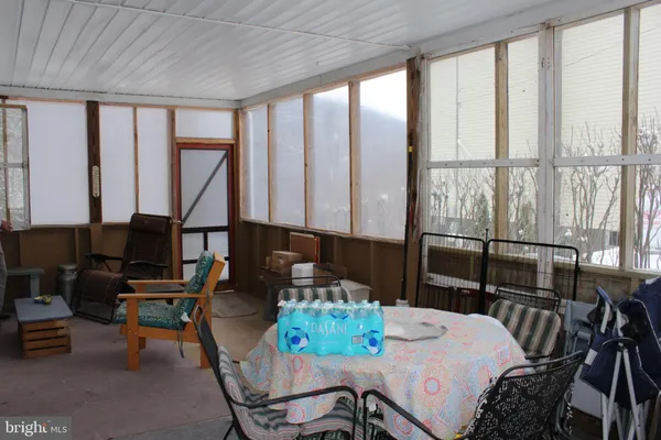 a dining room with furniture and a floor to ceiling window
