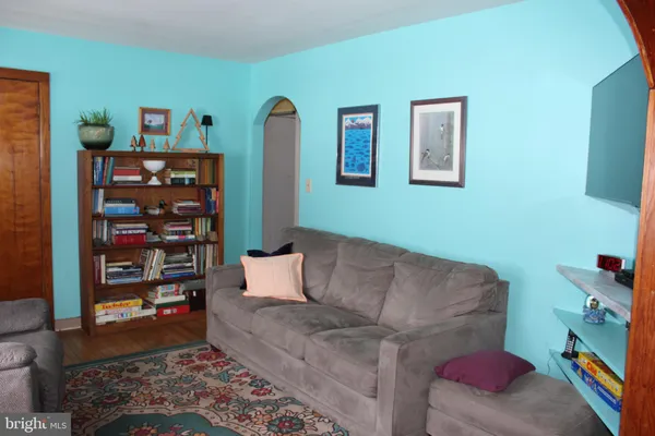 a living room with furniture and a book shelf