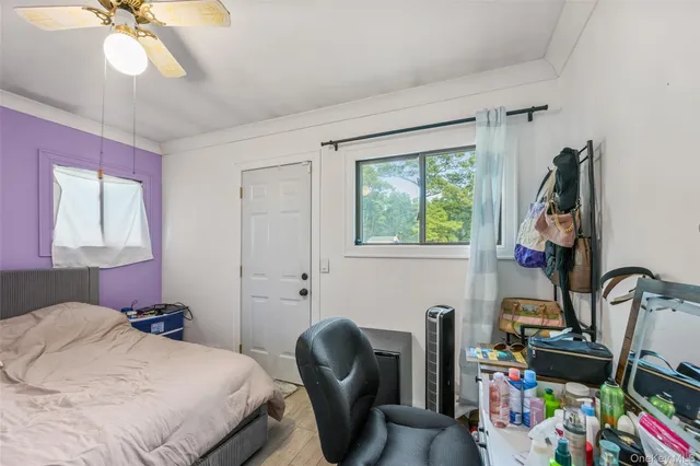 a bedroom with a bed a dresser and a book shelf
