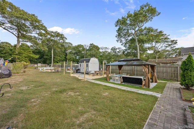 a view of a backyard with sitting area