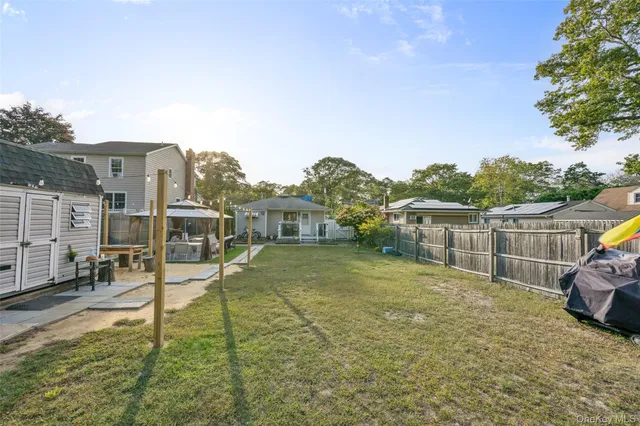 a view of a backyard with wooden fence