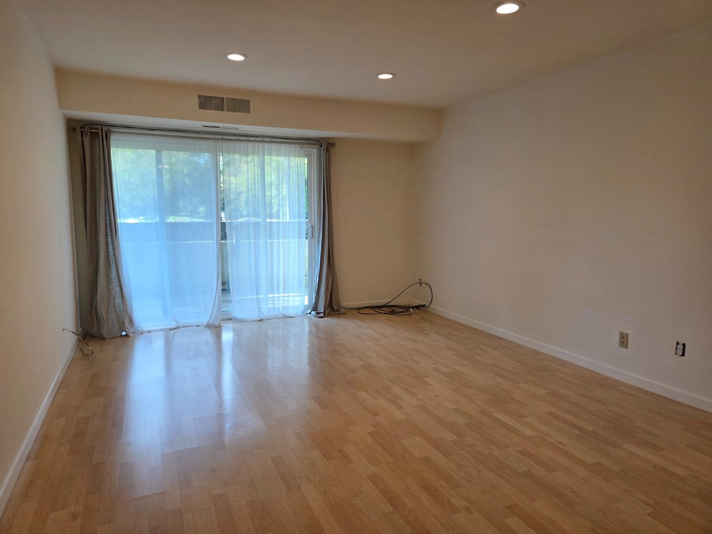 309 Tradewinds Drive, Unit 3 San Jose, CA 95123 - Photo 12 of 34 an empty room with wooden floor and windows