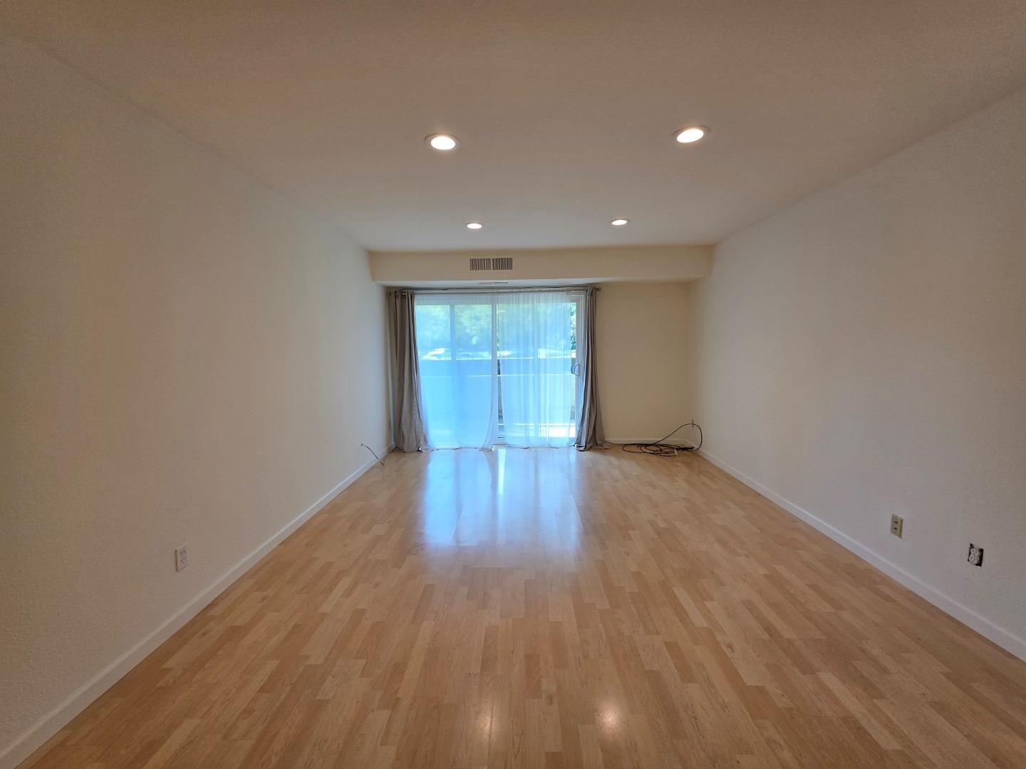 309 Tradewinds Drive, Unit 3 San Jose, CA 95123 - Photo 13 of 34 a view of empty room with wooden floor and fan