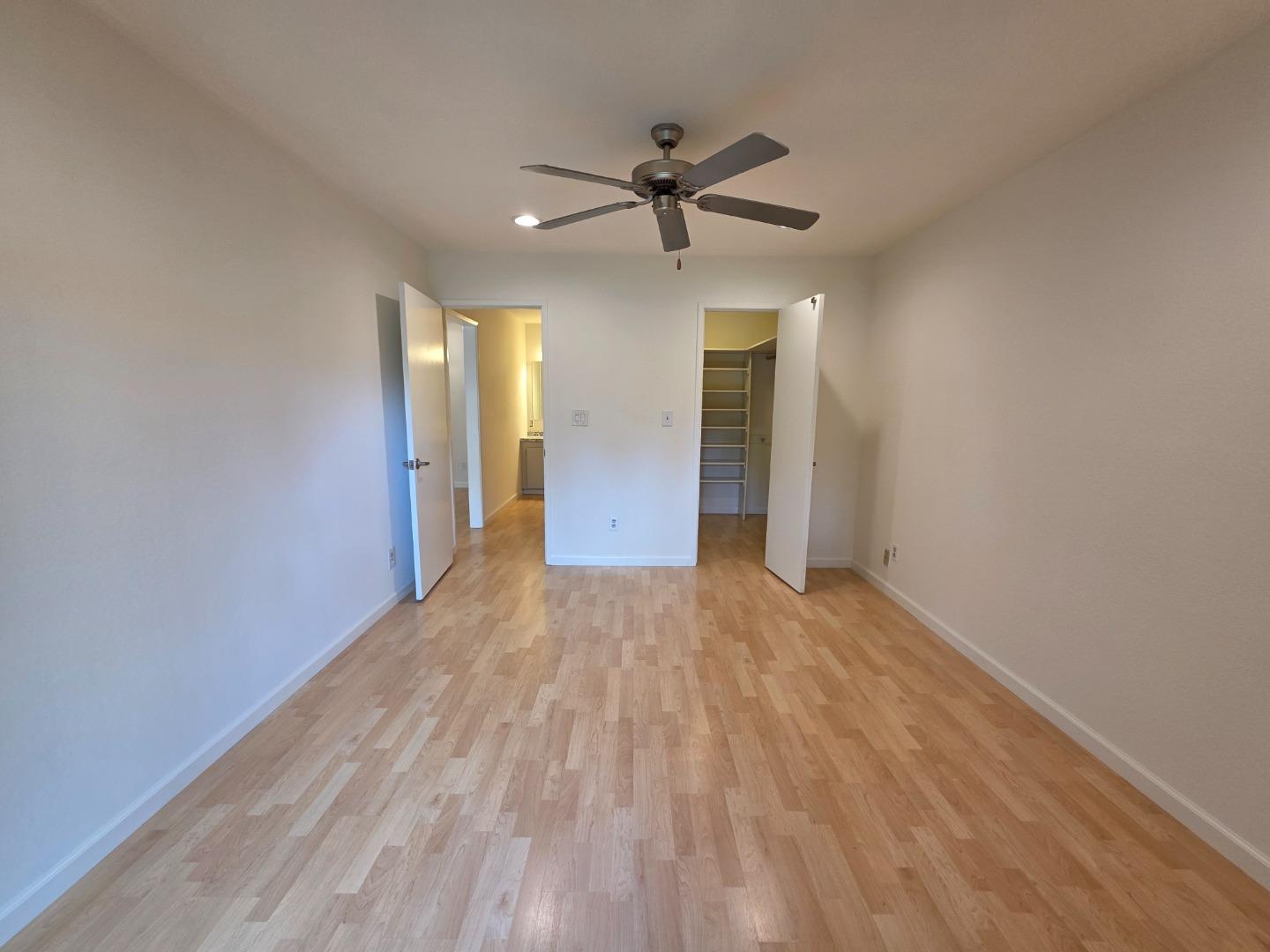 309 Tradewinds Drive, Unit 3 San Jose, CA 95123 - Photo 15 of 34 a view of an empty room with wooden floor and a ceiling fan