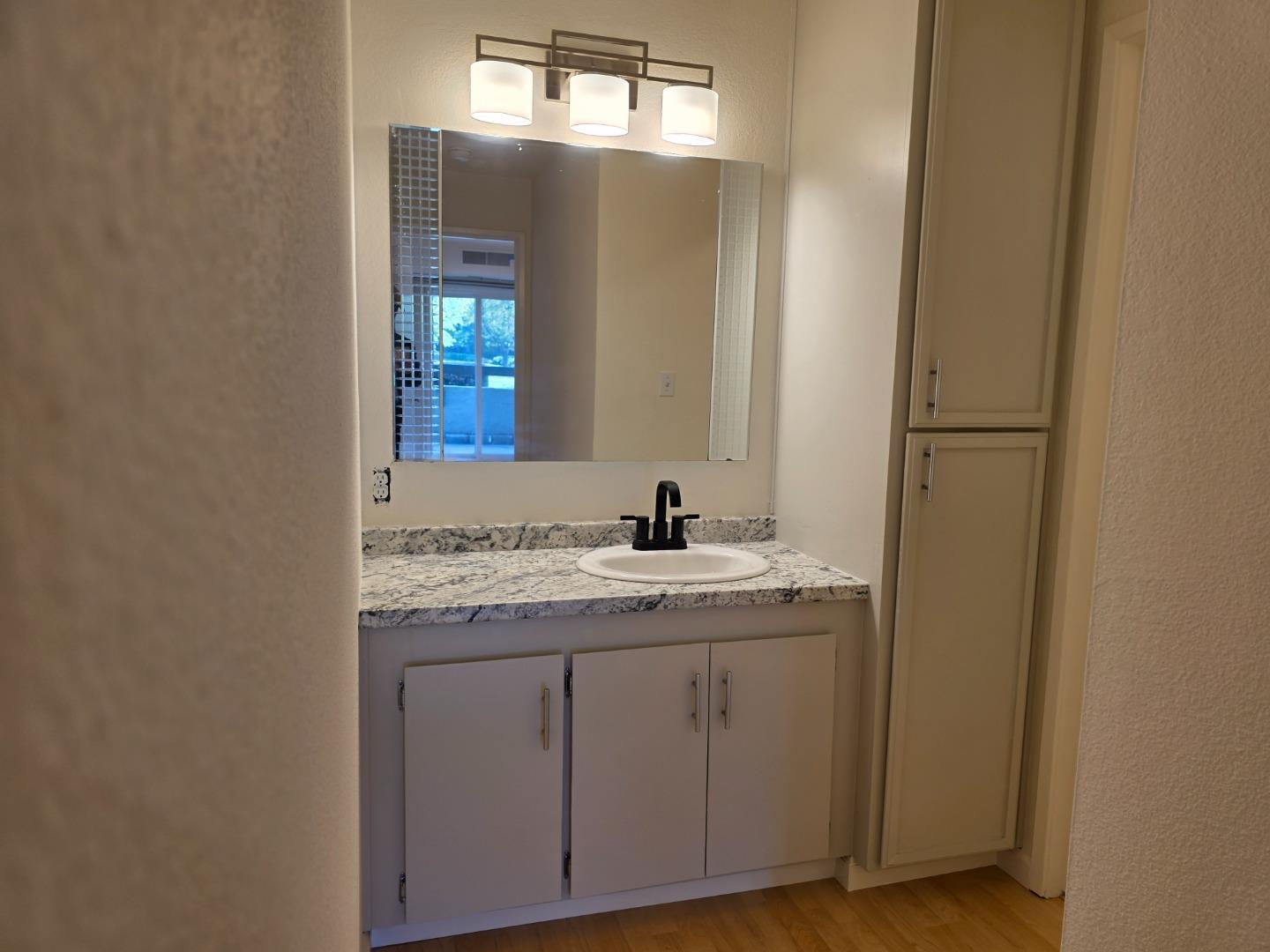 309 Tradewinds Drive, Unit 3 San Jose, CA 95123 - Photo 19 of 34 a bathroom with a granite countertop sink and a mirror