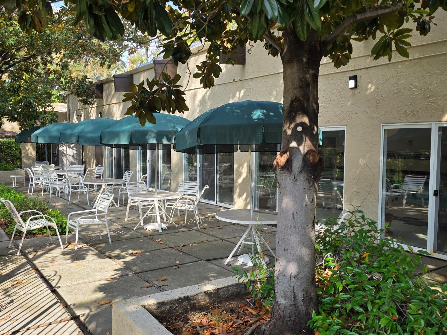 309 Tradewinds Drive, Unit 3 San Jose, CA 95123 - Photo 28 of 34 a view of a patio with table and chairs under an umbrella