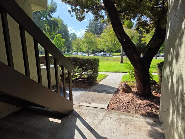 a view of a porch with furniture and a yard